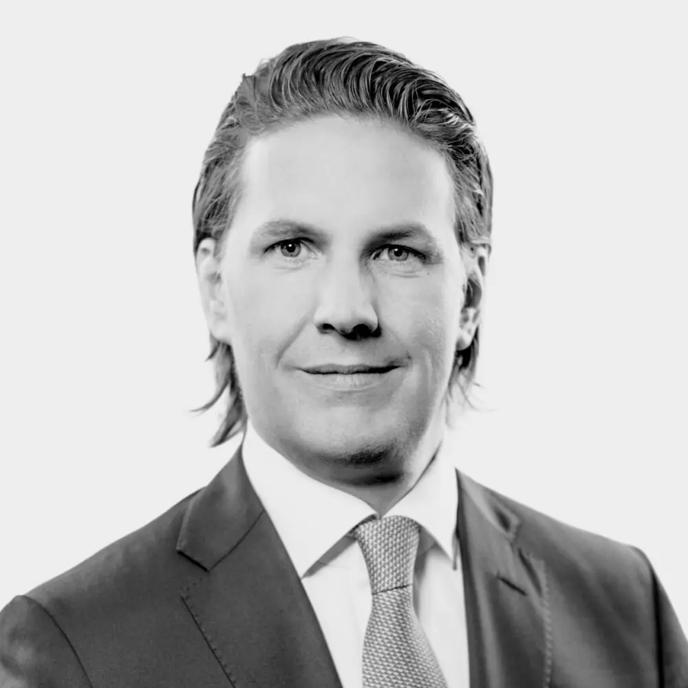 A professional individual poses confidently, exemplifying expertise in credit and investment strategies for funds.